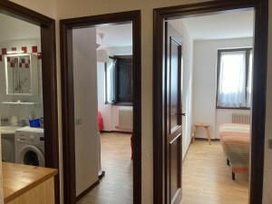 a hallway of a room with a kitchen and a bathroom at 031 Trilocale piano terra, Giustino in Giustino