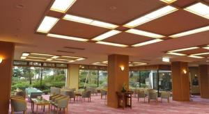 a dining room with tables and chairs in a building at Hotel Masyuu in Shibata