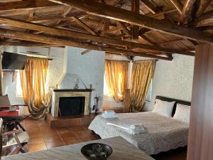 a bedroom with two beds and a fireplace at Δωμάτια Εξοχή-With fireplace and view to the sea in Elíki