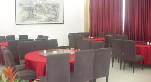 a conference room with tables and chairs and red table cloth at Super 8 Hotel Xi'an Dayan Tower Heping Gate Metro Station in Xi'an +143 photos