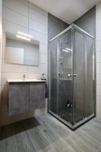 a bathroom with a shower and a sink at St Paul's Apt Distant SeaViews in St. Paul's Bay