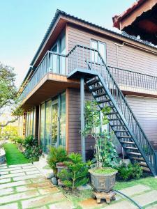 a house with a staircase on the side of it at Dream House Homestay Hotel in Xóm Trương Quít +22 photos
