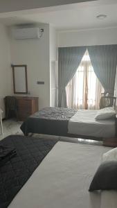 Postel nebo postele na pokoji v ubytování Green inn Trinco