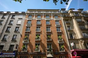 a tall brick building with potted plants in front of it at Beaugrenelle St-Charles Tour Eiffel in Paris