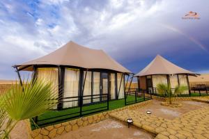 two tents in the desert with a rainbow in the sky at Desert Rose Village in Al Khatim +27 photos