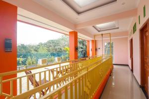 a balcony with orange walls and a large window at Happy Family Eksklusif Yogyakarta in Beran-kidul
