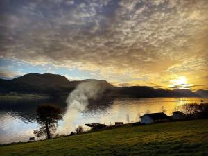 Stokkeにある5 person holiday home in averøyの夕日を背景にした水中の火