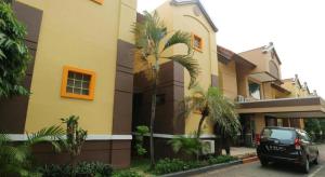 a car parked in front of a building at Hotel Permata Bandara in Gombolpaya