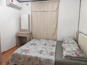 a small bedroom with a bed and a mirror at Zhan Ruralstay in Kuala Perlis