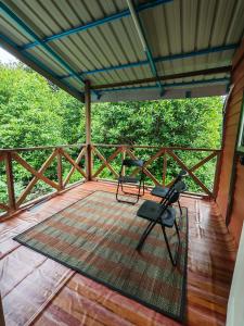 a screened porch with a table and chairs on it at Zhan Ruralstay in Kuala Perlis