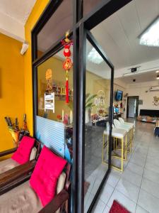 a living room with pink pillows on a couch at DK1Hostel in Chaweng +21 photos