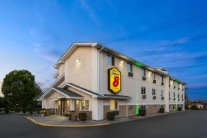 a hotel building with a sign on the side of it at Super 8 by Wyndham Latham - Albany Airport in Latham