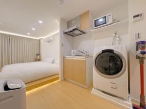 a bedroom with a bed and a tv in it at star house akihabara ueno tokyo in Tokyo