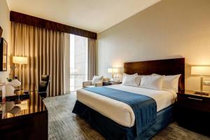 a hotel room with a bed and a large window at Wyndham Santiago Aeropuerto in Santiago