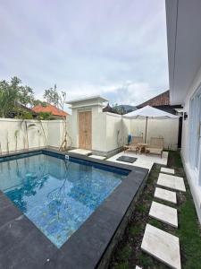 a swimming pool in the backyard of a house at Amed Happy House in Amed