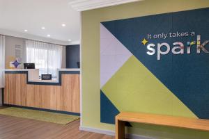 an office with a colorful wall with the words it only takes a spark at Spark by Hilton Springfield Eugene in Eugene