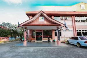 a building with a car parked in front of it at Pelangi Marang by Tanjung Sukai in Marang