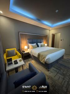 a hotel room with a bed and a couch at سوات للشقق المخدومة 5 in Al Khobar