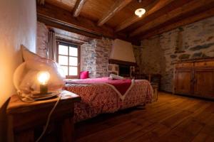 a bedroom with a bed and a window in a building at Les Calades in Les Estables