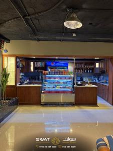 a restaurant with a bar and a counter with alcohol at سوات للشقق المخدومة 5 in Al Khobar