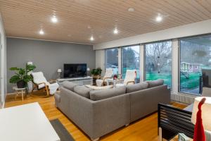 a living room with a couch and a tv at Villa Santa's Star II in Rovaniemi