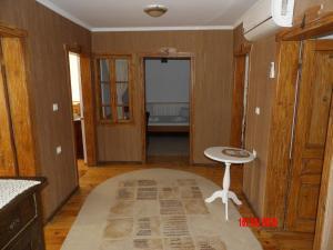 a room with a table and a stool on a rug at Етаж от Хаджи Марковата къща за гости - град Дряново in Dryanovo