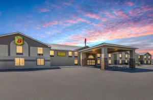 a large building with a parking lot in front of it at Super 8 by Wyndham Shepherdsville - Louisville South I65 in Shepherdsville