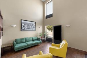 a living room with a couch and two chairs at Super 8 by Wyndham Shepherdsville - Louisville South I65 in Shepherdsville