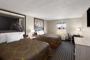 a hotel room with two beds and a flat screen tv at Super 8 by Wyndham Shepherdsville - Louisville South I65 in Shepherdsville +25 photos
