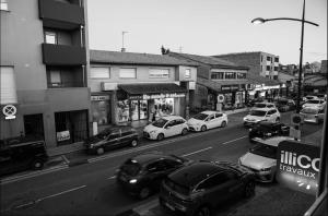 a black and white photo of cars parked on a city street at Évasion chic à Aucamville - Parking Privé - CLIM in Aucamville