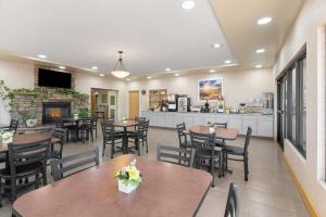 a restaurant with tables and chairs and a fireplace at Days Inn by Wyndham Chino Valley in Chino Valley