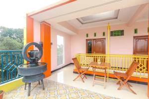 a room with a balcony with a table and chairs at Happy Family Eksklusif Yogyakarta in Beran-kidul