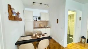 a kitchen with a table and chairs in a room at Maple Lodge in Braşov