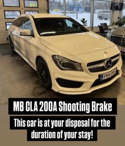 a white car is parked in a garage at Lapland Riverside Home in Rovaniemi