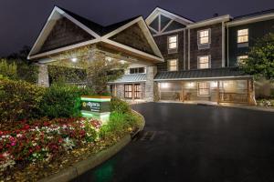 a house with a driveway and flowers in front of it at La Quinta by Wyndham Boone in Boone
