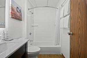 a white bathroom with a toilet and a shower at La Quinta by Wyndham Sturbridge in Sturbridge +32 photos