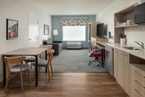 a kitchen and living room with a table and chairs at Home2 Suites By Hilton Cleveland, Tn in Cleveland