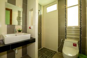 a bathroom with a sink and a toilet and a window at Living Chilled Koh Tao in Koh Tao