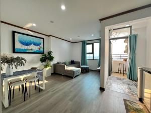 a living room with a couch and a table at Da Nang Daisy Apartment in Danang