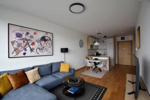 a living room with a couch and a table at Panorama Studio in Novi Sad