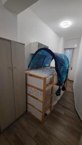 a bedroom with a bunk bed with a blue tent at Rocca view central flat in Arona