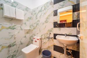 a bathroom with a sink and a toilet at VSA Residency in Pūrnānkuppam