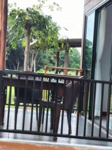 a balcony with a chair and a window at Baan Seaview Sunset in Phra Ae beach