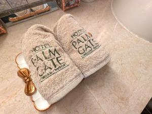 a pair of towels sitting on a bathroom floor at Hotel PALM GATE in Fukuoka +51 photos
