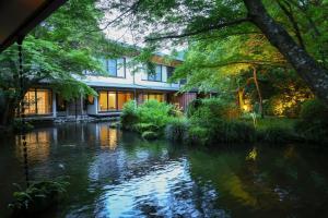 a house with a river in front of it at Oku Yugawara Tsubaki in Yugawara