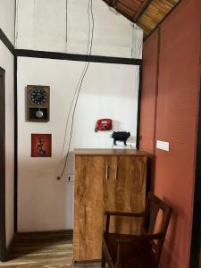 ein Zimmer mit einem Holzschrank und einem roten Auto an der Wand in der Unterkunft Apricot Cottage in Kozhikode