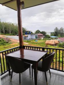 a table and chairs on a balcony with a view at Baan Seaview Sunset in Phra Ae beach