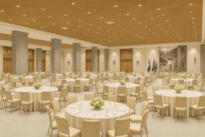 a large banquet hall with white tables and chairs at Diamonds Bijoux in Bwejuu +33 photos