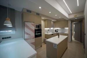 a kitchen with a sink and a stove at POSEIDON Executive Suite in Athens +57 photos