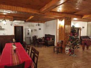 a living room with a christmas tree and a dining room at Етаж от Хаджи Марковата къща за гости - град Дряново in Dryanovo